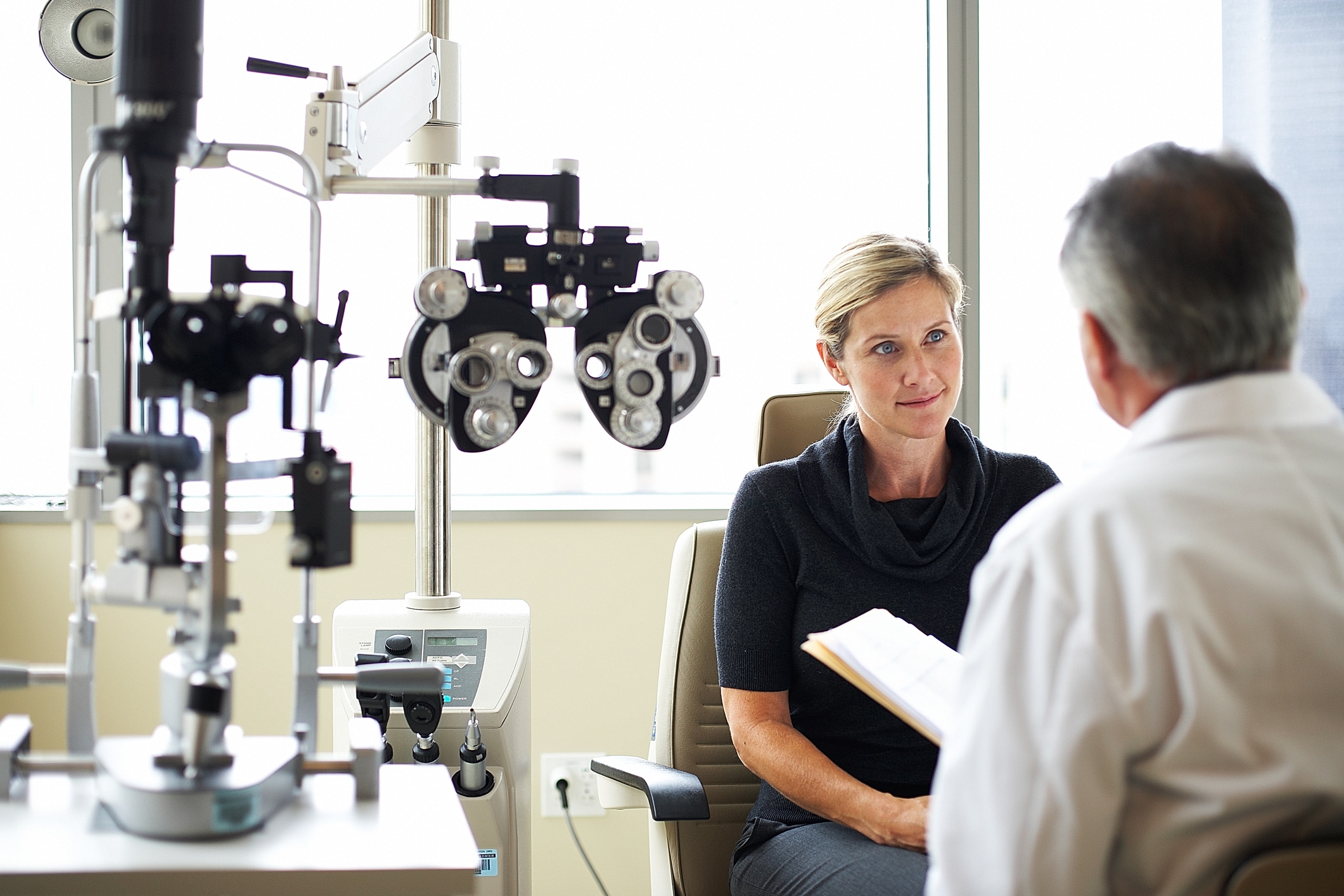 A woman listens to her opthamologist Eye & Contact Lens Associates of